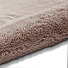image of soft rose pink rug rolled up on one end