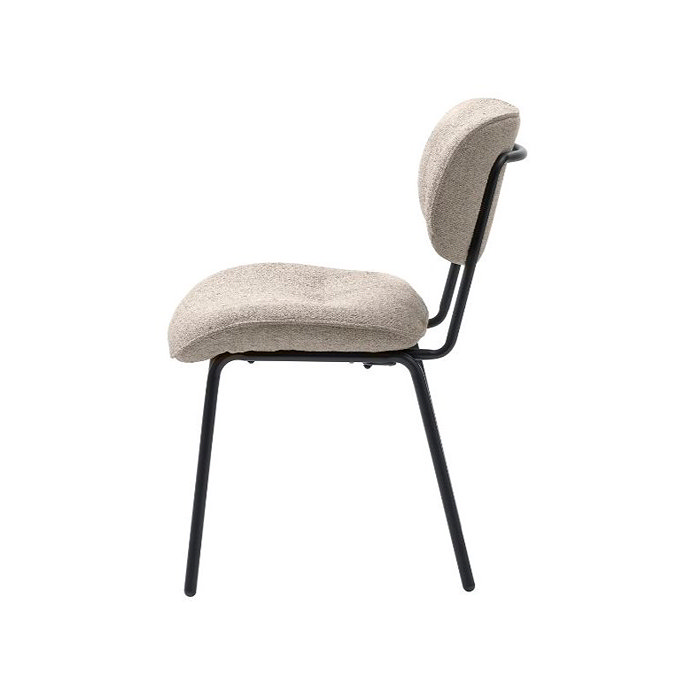 side on image cut out on white background of off-white fabric dining chair with black steel legs