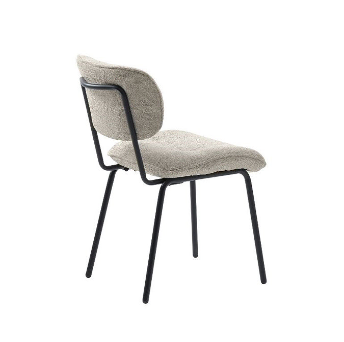 side on image cut out on white background of off-white fabric dining chair with black metal legs and back support