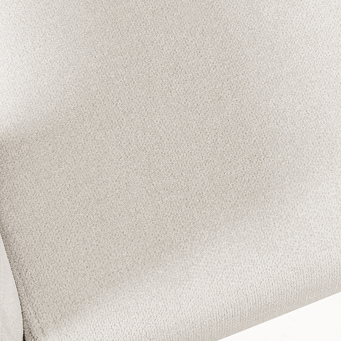 close up image on upholstered cream fabric of tub accent chair