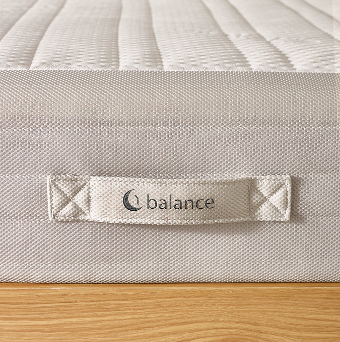 close up on fabric handle of mattress with 'balance' stitched on it