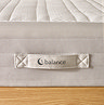 close up on fabric handle of mattress with 'balance' stitched on it
