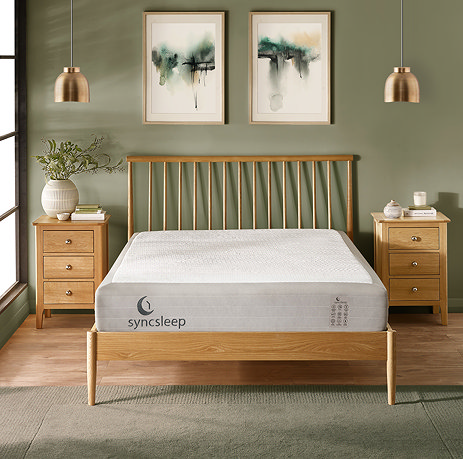 image of deep white mattress on double slatted bed in front of sage green wall