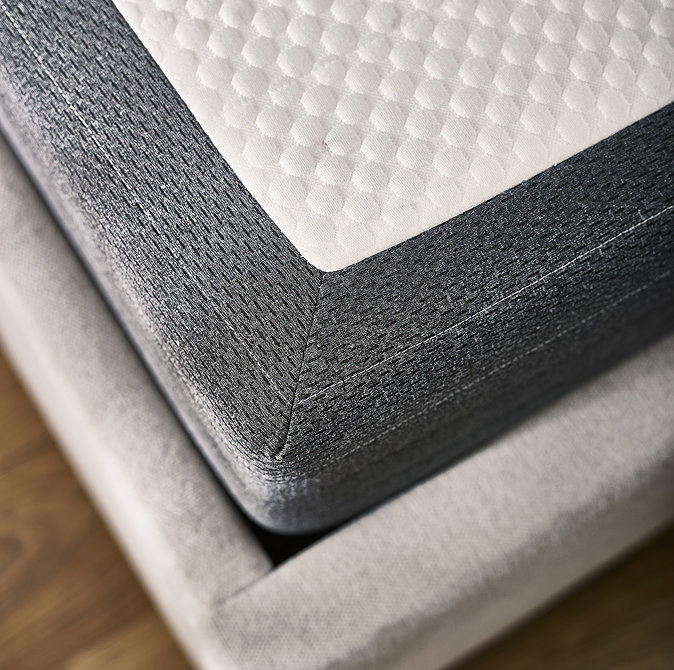 image taken from above of corner of mattress with grey sides