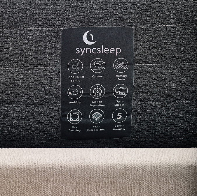 image of dark grey side of mattress with care label