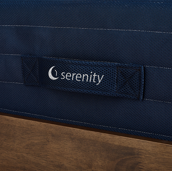 close up on fabric handle on side of navy blue mattress with the syncsleep logo embroidered in white