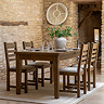image of dark oak dining table retracted from extended position to seat 4