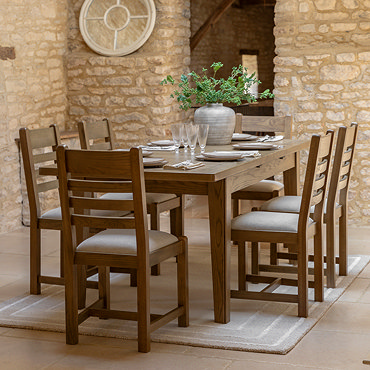 image of dark oak dining table retracted from extended position to seat 4