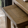 close up on smaller dark oak nesting table slotted slightly underneath larger counterpart