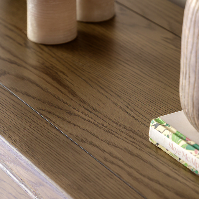 close up on wood grain of dark oak console table