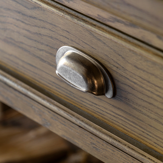 close up on wood grain and metal handle of dark oak console table