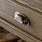 close up on wood grain and metal handle of dark oak console table