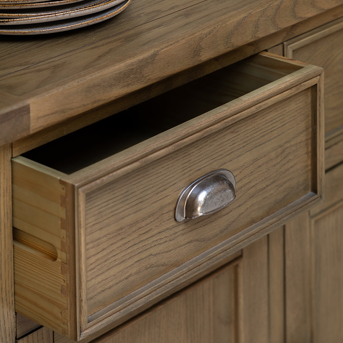 close up on dark oak sideboard drawer with metal arched handle
