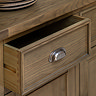 close up on dark oak sideboard drawer with metal arched handle