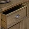 close up on dark oak sideboard drawer with metal arched handle
