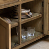 close up on open drawer of dark oak sideboard, revealing shelving space inside for glassware and crockery