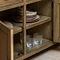 close up on open drawer of dark oak sideboard, revealing shelving space inside for glassware and crockery