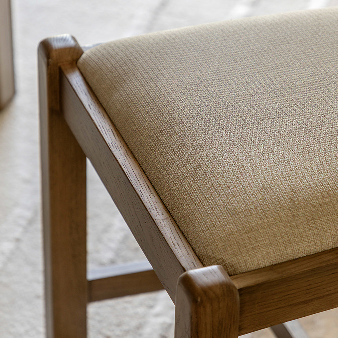 close up image of padded seat of dark oak chair