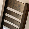close up image of slatted backrest of dark oak chair