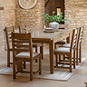 wide image of six wooden slatted dining chairs around a dining table