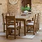 wide image of six wooden slatted dining chairs around a dining table