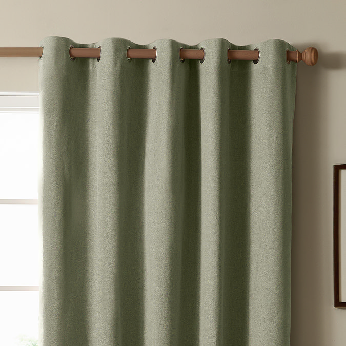The Ultimate Blackout Eyelet Curtains in Sage over a window image
