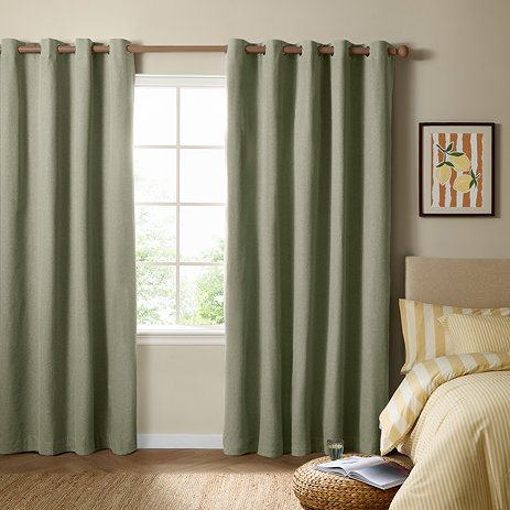 The Ultimate Blackout Eyelet Curtains in Sage over a window image