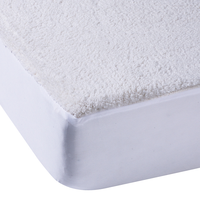 corner of a mattress covered with a sherpa fleece underblanket