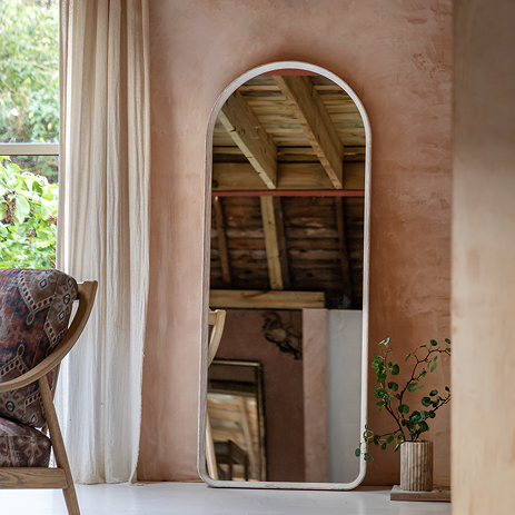 image of limed oak rounded top floor length mirror against a light brown wall