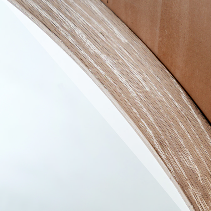 close up on limed oak wash edge of round wall mirror