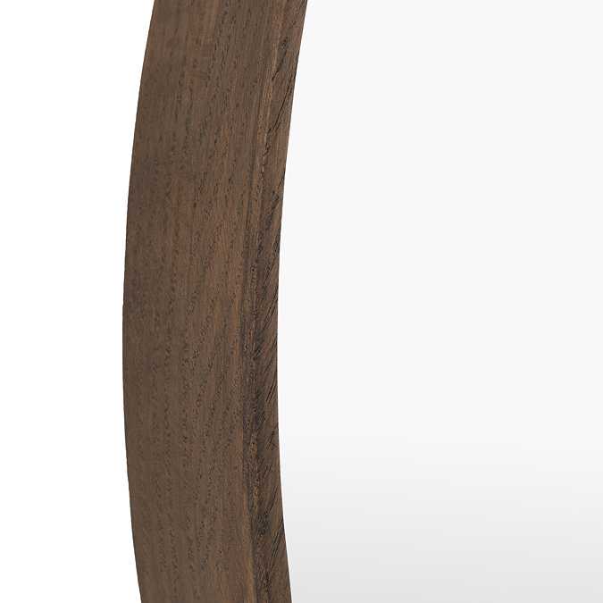 close up image of walnut coloured rounded wood frame of wall mirror