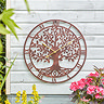 image of larger bronze wall clock on a white-painted wooden shed wall