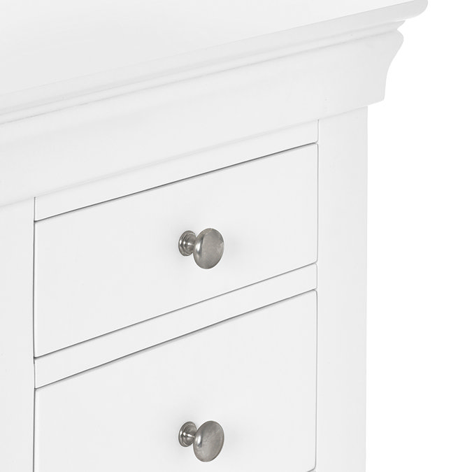 close up image of white pine dressing table drawers with silver knobs