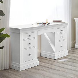 white pine dressing table with three drawers on each side, up against window