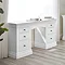 white pine dressing table with three drawers on each side, up against window