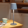 image of minimalist grey lamp on kitchen table emitting warm glow
