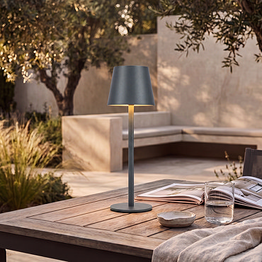 image of minimalist grey lamp on kitchen table emitting warm glow