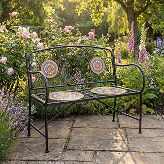 image of mosaic and cast iron bench in sunny garden