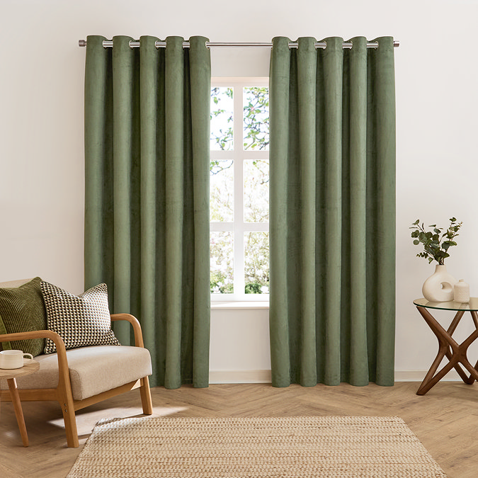 Verso Reversible Blackout Eyelet Curtains in Green over a window image