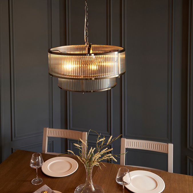 image taken from slightly above of ribbed glass pendant light over a dining table