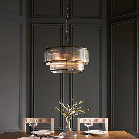 image of ribbed glass tiered pendant light with five bulbs, over a dining table