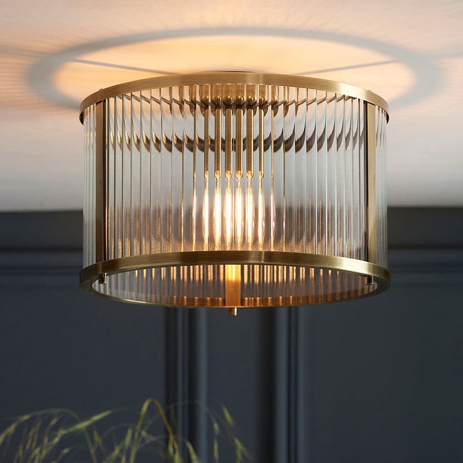 image of ribbed ceiling light in antique brass, close to cream ceiling