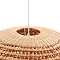 close up image of top of rattan hanging oval light shade, where white cable goes into shade through circle