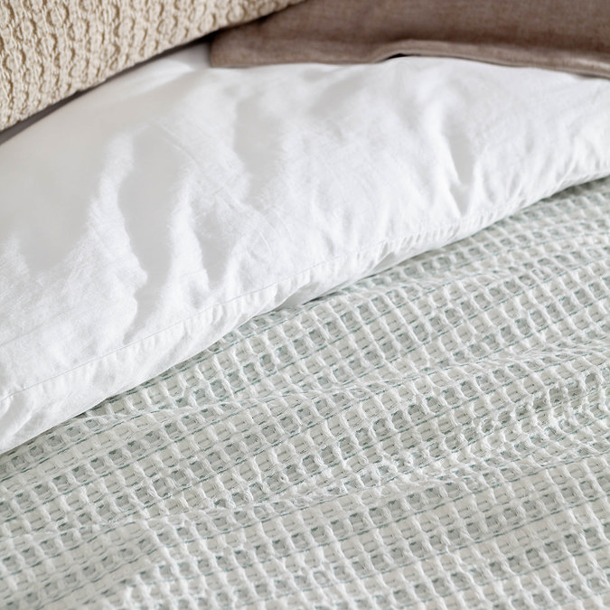 waffle textured bedspread close up on bed image 2