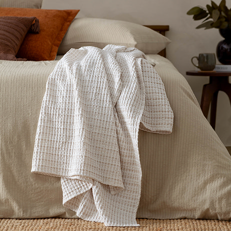waffle textured throw natural on bed image
