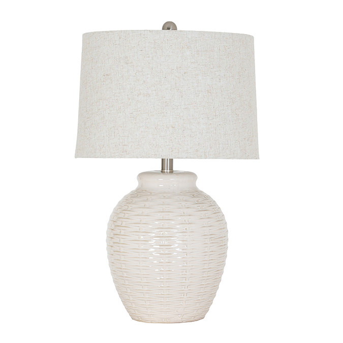 image cut out on white background of white ceramic lamp with basketweave detailing