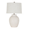 image cut out on white background of white ceramic lamp with basketweave detailing