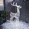 white rattan light up reindeer in snow at the front of the house.