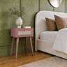 image of clay pink 1 drawer nightstand with rattan front, next to bed with clay pink pillows