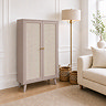 image of taupe two door sideboard with rattan front, on light wood flooring of living room scene